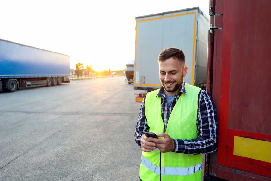 A happy Esso and Mobil fleet card truck driver uses the app to make purchases at his stop.