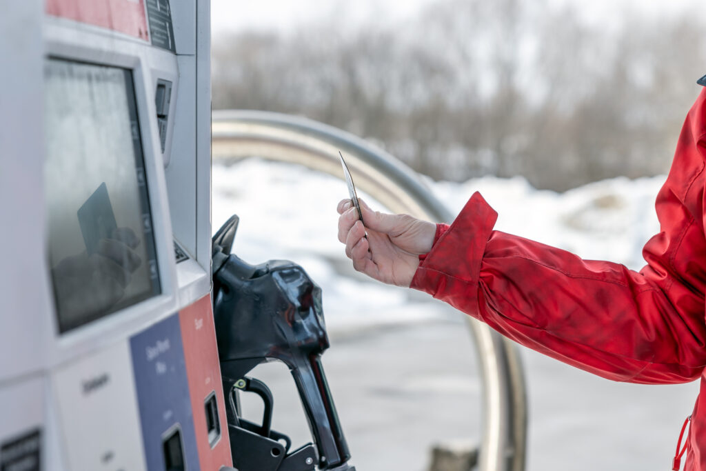 A fleet driver uses their Esso fuel card to purchase fuel at a station.