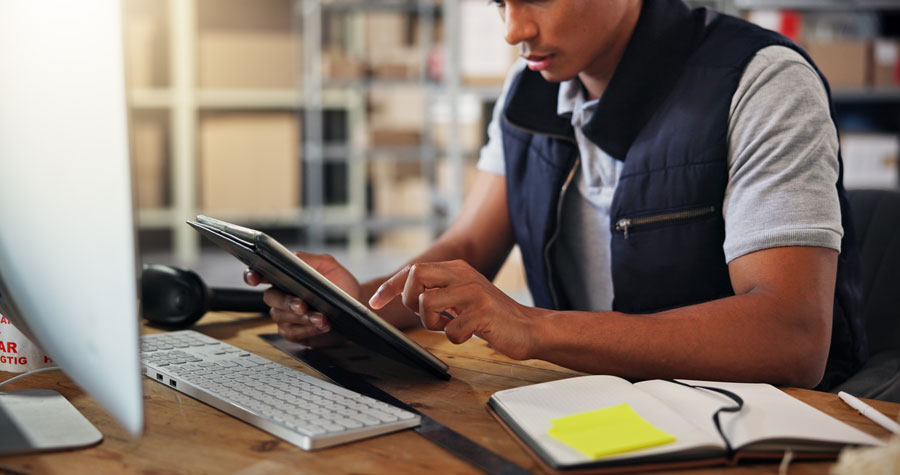 A fleet manager reviews data analytics from the fleet fuel cards he uses with his fleet of delivery trucks.