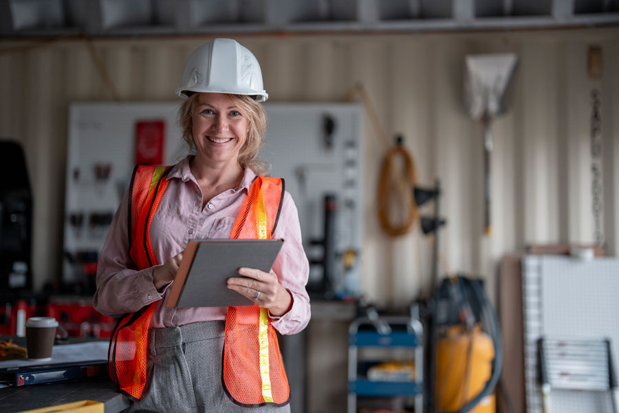 A fleet owner happily reviews fuel usage in real-time from her fleet on her tablet.