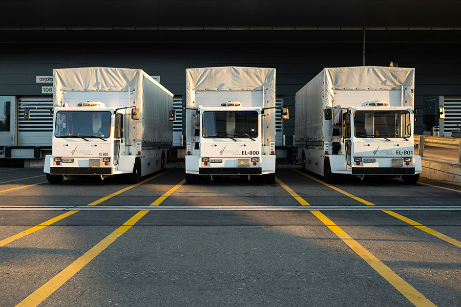A fleet of trucks at a manufacturing plant.
